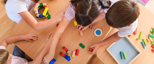 Students playing at the table with blocks